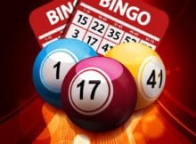 Bingo Balls and Bingo Cards over a Glowing Golden Background